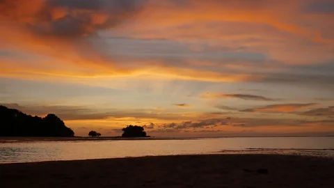 Soft sea wave breaking sand shore beach, silhouette mountain and island, airp Stock Footage 128298113