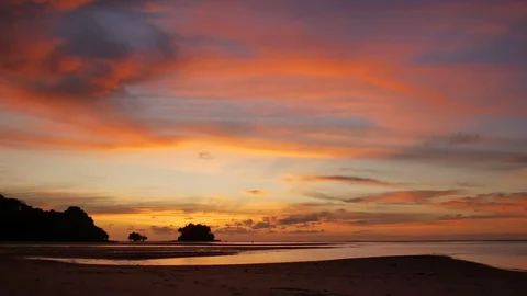 Soft sea wave breaking sand shore beach, silhouette mountain and island, clou Stock Footage 128298326