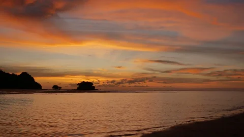 Soft sea wave breaking sand shore beach, silhouette mountain and island, airp Stock Footage 128298478