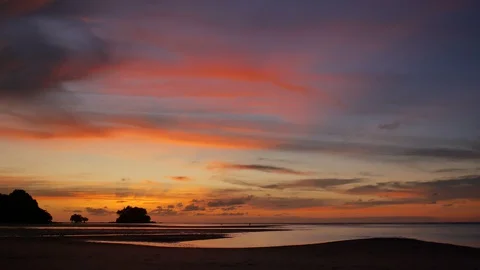 Soft sea wave breaking sand shore beach, silhouette walking man, mountain and Stock Footage 128299786