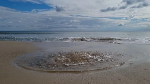 Soft sea waves rolling on sandy beach under cloudy sky Stock Footage 319252327