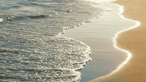 Soft sea waves rushing on sandy beach on sunset Stock Footage 65408854
