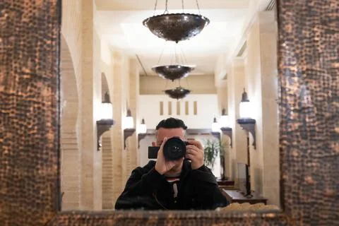 Soft selective focus of lens with blurred male photographer taking photo of h Stock Photos