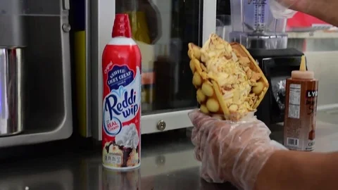 Soft serve ice cream machine waffle cone vanilla toppings chocolate Video stock 83965995