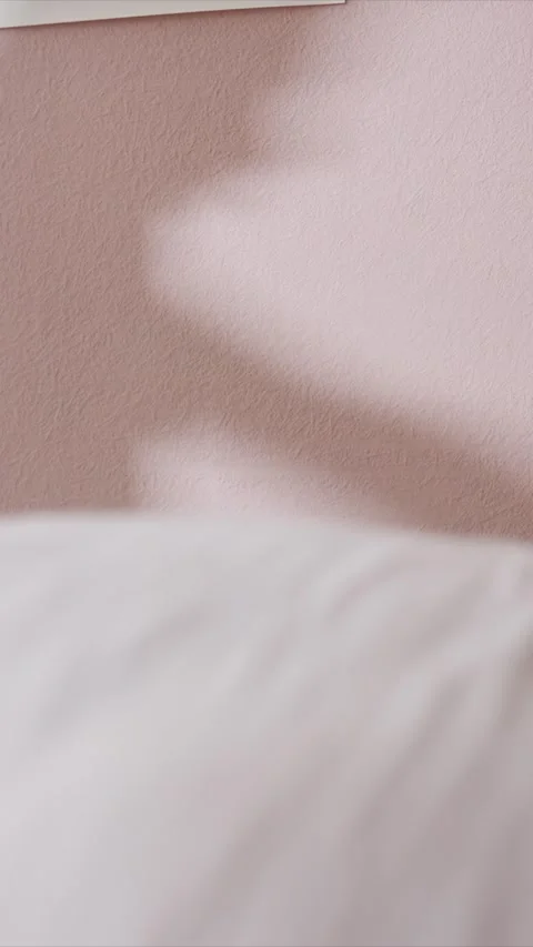 Soft Shadows Move Across Pink Textured Wall in Closeup showing shadow light Stock Footage 346794236