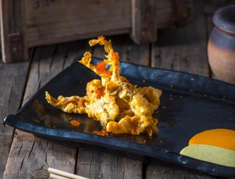 SOFT SHELL CRAB TEMPURA served in a dish isolated on wooden background side v Stock Photos