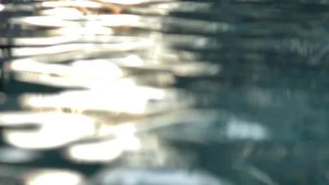 Soft shimmering light reflections appear across rippling water surface forming Stock Footage 330948099