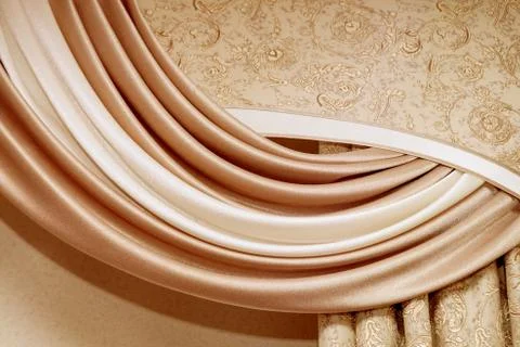 Soft silk curtains with decorative elements and folds close-up Foto stock