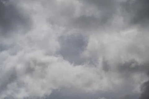 Soft silver cloud break reveals. Subtle blue peek, serene calm mood, minimal  写真素材