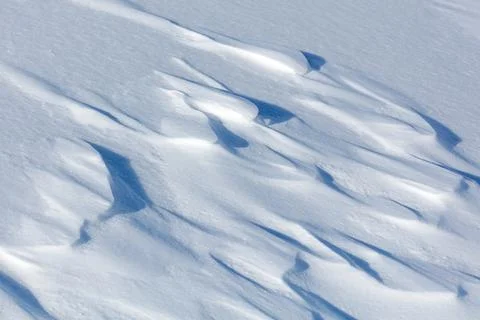 Soft snow blankets undulating terrain with gentle, flowing patterns Stock Photos