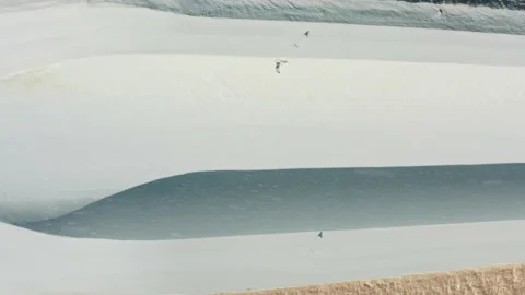 Soft snow falling on snowboard half pipe, free-rider jumping high above slope 스톡 동영상 165702311