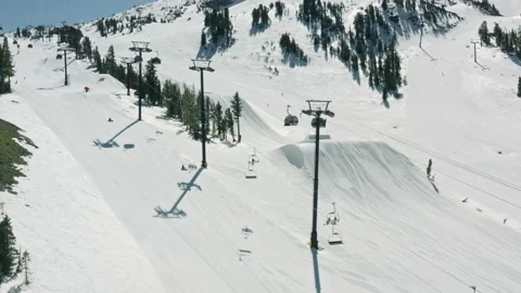 Soft snow flakes falling on ski chairs at Mammoth mountain resort on winter day Video stock 165702353