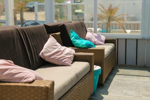 Soft sofas with colorfull pillows in the beach cafe terrace. Zandvoort, the N Stock Photos