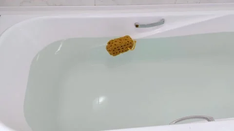 Soft Sponge Drifting in Clean Bathwater: A Morning of Stillness Stock Footage 313378627