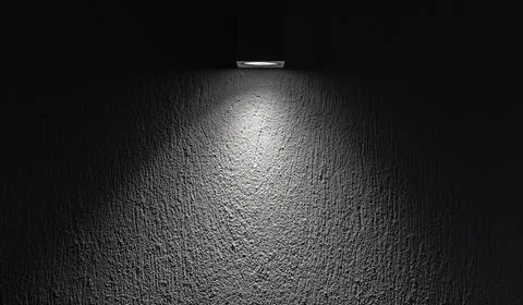 Soft spot light beam highlighting a textured wall, abstract background Stock Photos