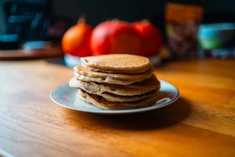Soft Stack of Pancakes on a Plate Placed on A Wooden Table with Hokkaido Pu.. Stock Photos