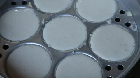 Soft steamed idlis are being prepared in the steamer stand. 動画素材 346766408