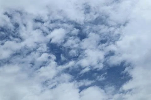 Soft Stratocumulus Clouds Drifting Across a Pale Blue Sky Overhead Stock Photos