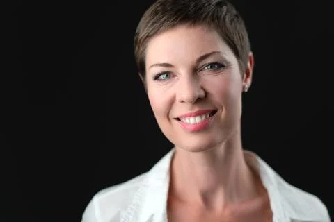 Soft studio portrait of attractive short haired smiling business woman in white Stock Photos