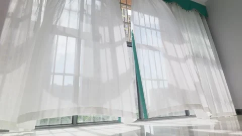 Soft summer breeze blows gently across white curtains 스톡 동영상 336933639