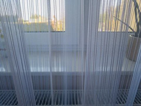 Soft sunlight filtering through sheer white curtains, creating a serene and Foto stock