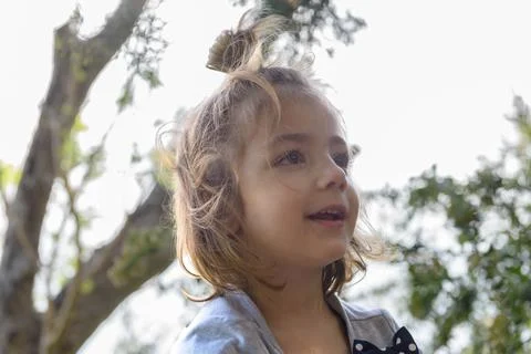 Soft sunlight glows behind a curious child Stockfoto's