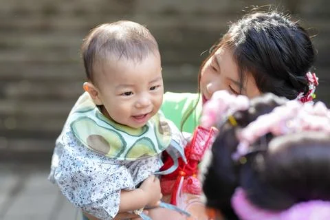 Soft sunlight glows on a smiling baby's face Stock Photos