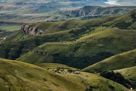 Soft sunlight reveals intricate patterns of rolling hills and rivers Stock Photos