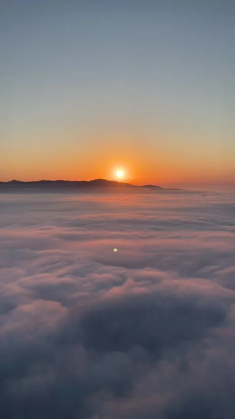 Soft sunrise glow over cloud-covered valleys at Montserrat Stock Footage 344409793