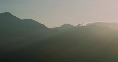 Soft Sunrise Light Over Mountain Layers with Atmospheric Mist Aerial Stock-Footage 331702422