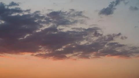 Soft Sunset Clouds with Warm Orange Horizon Sky Stock Photos
