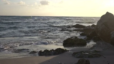 Soft Sunset Over Slow Motion Waves and Rocky Outcrop Видео 78211333
