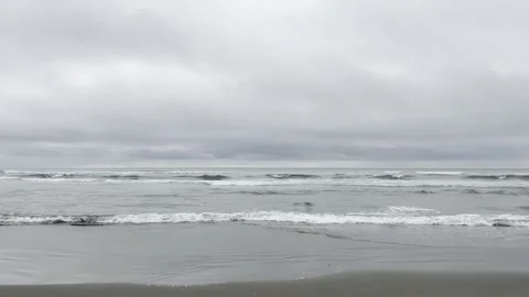 Soft Surf Washing Over Wet Sand Under Heavy Clouds Stock Footage 339378336