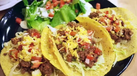 Soft Taco shells filled with mince meat, coriander and salsa on plate with salad Video stock 53796086