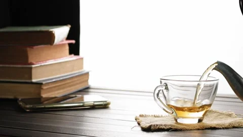 Soft tea cup focus Pour hot tea into the teacups placed on the table in slow mot Stock Footage 201917038