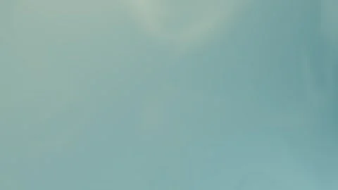 Soft teal blue ethereal gradient backdrop, seamless loop background. 4K. Stockbeeldmateriaal 309856069