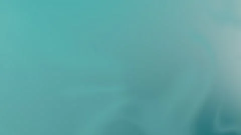 Soft teal gradient with smooth waves, perfect seamless loop background. 4K Stock Footage 309856098