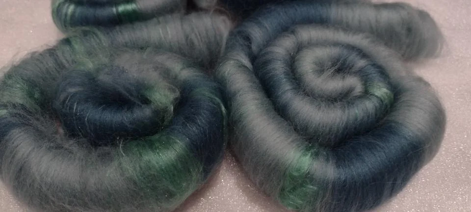 Soft teal round rolls of wool fiber art Stock Photos