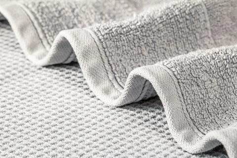 Soft terry towel folded in waves on a gray background close-up Foto stock