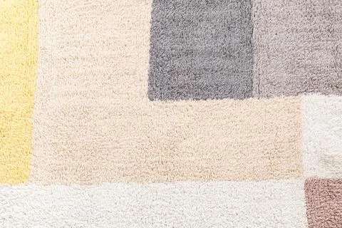 Soft textured carpet with geometric pattern in neutral tones, cozy home decor Stock Photos