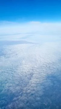 Soft textured cloud layer viewed from airplane window above the atmosphere under 스톡 사진