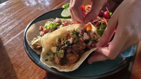 Soft tortilla taco vegetabe salsa and meat Mexican cuisine in diner plate Video stock 323575598