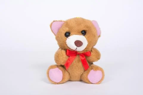 Soft toy bear with a red bow on a white background 스톡 사진