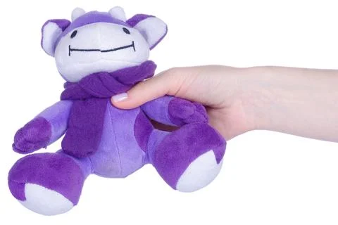 Soft toy cow in hand Stock Photos
