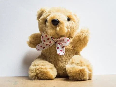 Soft toy fluffy bear sitting on a wooden board Stock Photos