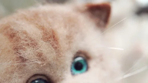 Soft toy handmade: a red-haired smiling cat with white stripes 库存影片 79450477