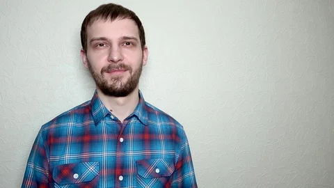Soft toy hits the face of a bearded young man, slow motion 動画素材 109503195