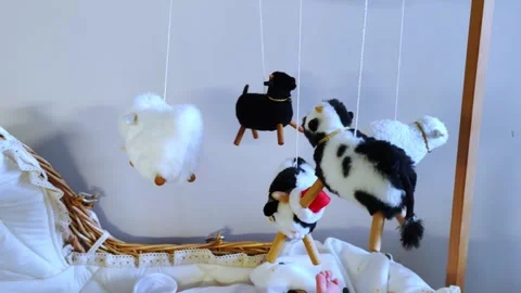 Soft toys circle above the crib, creating a calm environment for the baby. Stock Footage 286199948