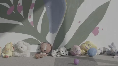 Soft toys lined up against a wall in a nursery Video stock 244706780