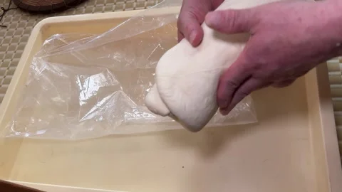 Soft Udon Dough Spiral from a Plastic Bag, Handmade Japanese Noodles Stock Footage 343792435